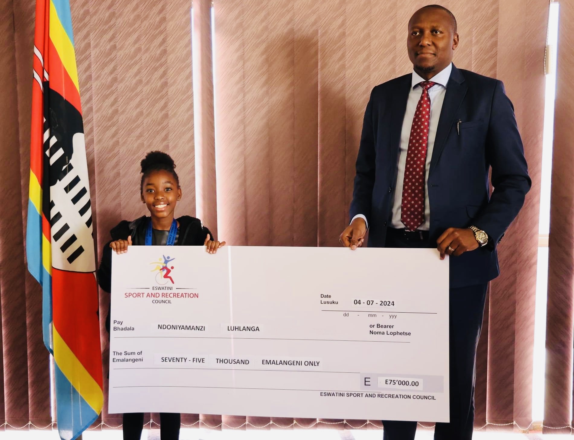 Prime Minister Russell Mmiso Dlamini presents R75,000.00 to Dance World Cup hero Ndoniyamanzi Luhlanga,says child made history.