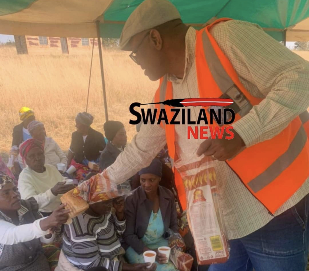  ESWATINI POVERTY SITUATION: Picture of royalty connected MP Lutfo Dlamini distributing pieces of bread.