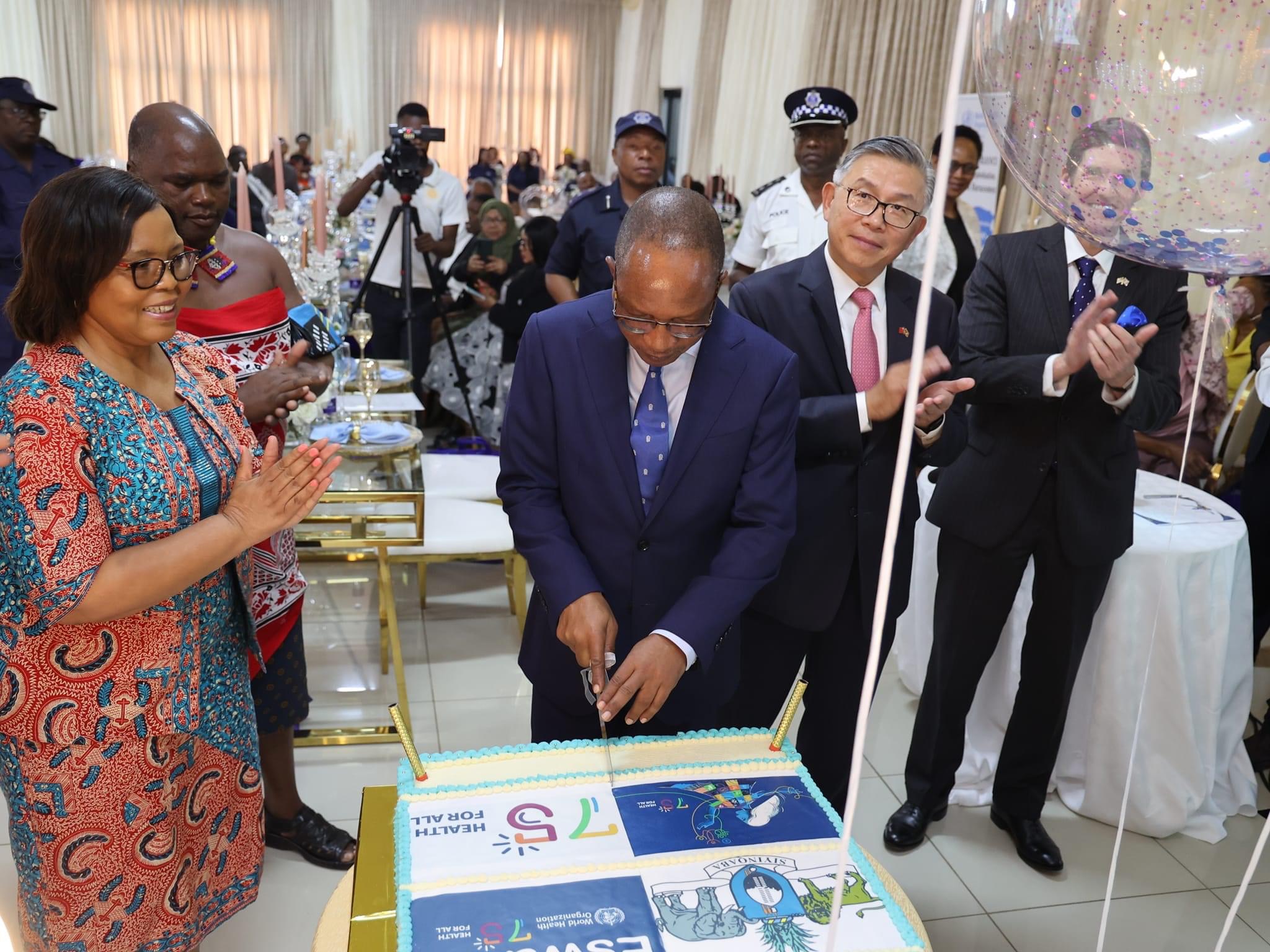 Prime Minister Cleopas Dlamini cuts cake during World Health Organization(WHO) 75th Anniversary.