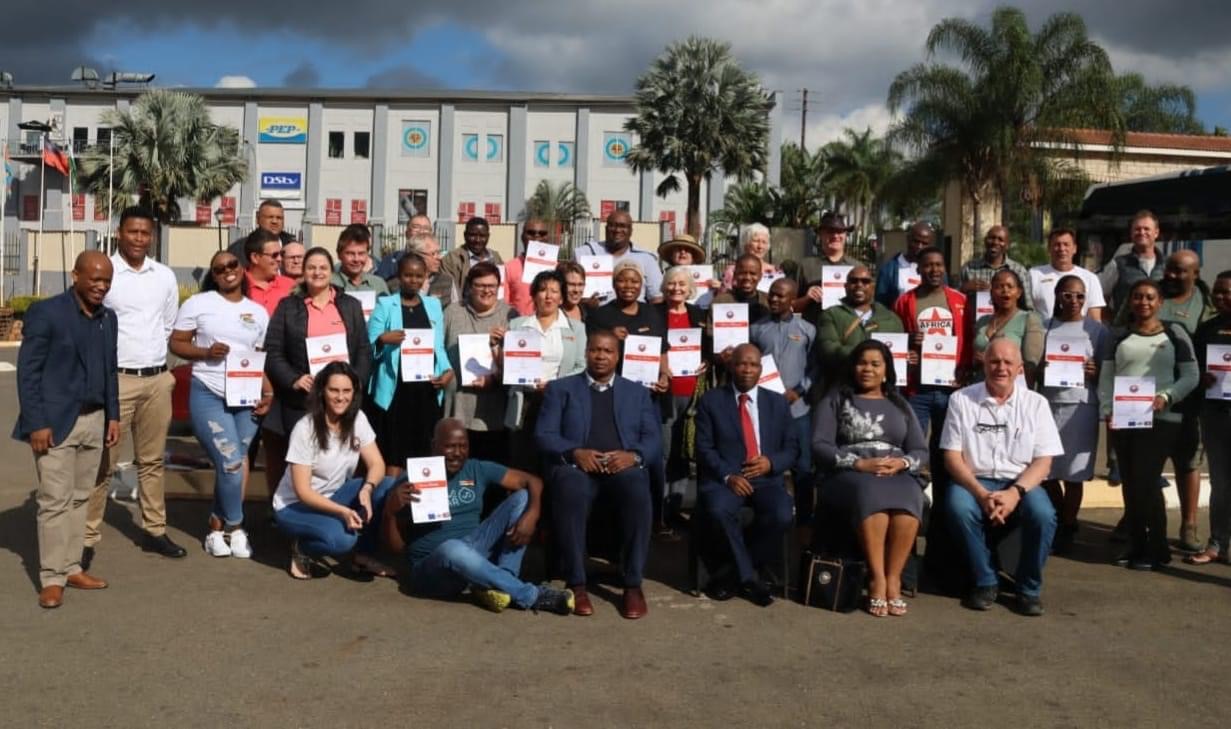 Tourism Minister Moses Vilakati honors Tour Guides with certificates.