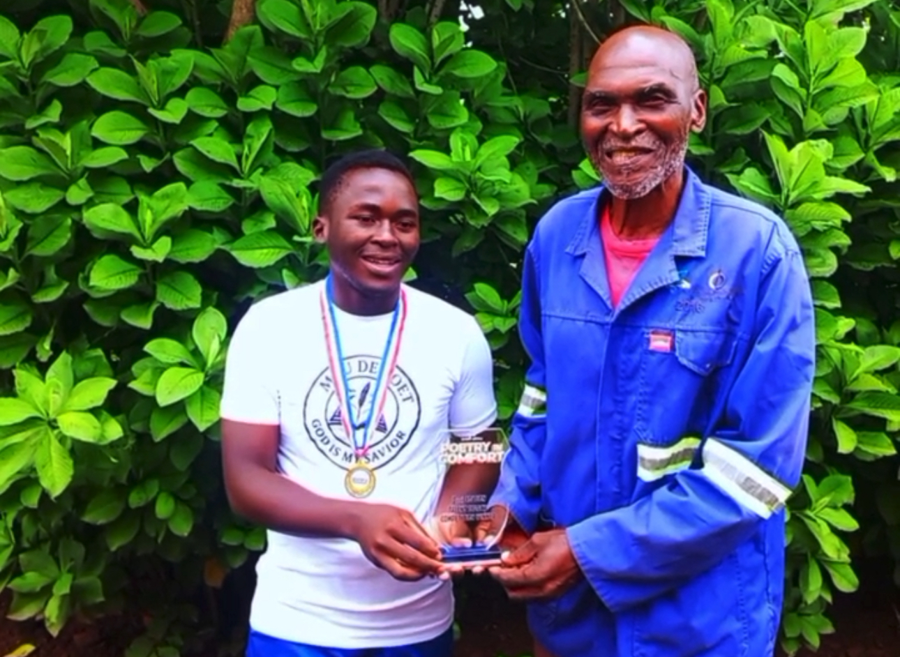 Poet Mvuselelo ‘Mvu’ Sihlongonyane of Ncandweni presents award to his grandfather after winning “Poetry in Comfort” Competition.